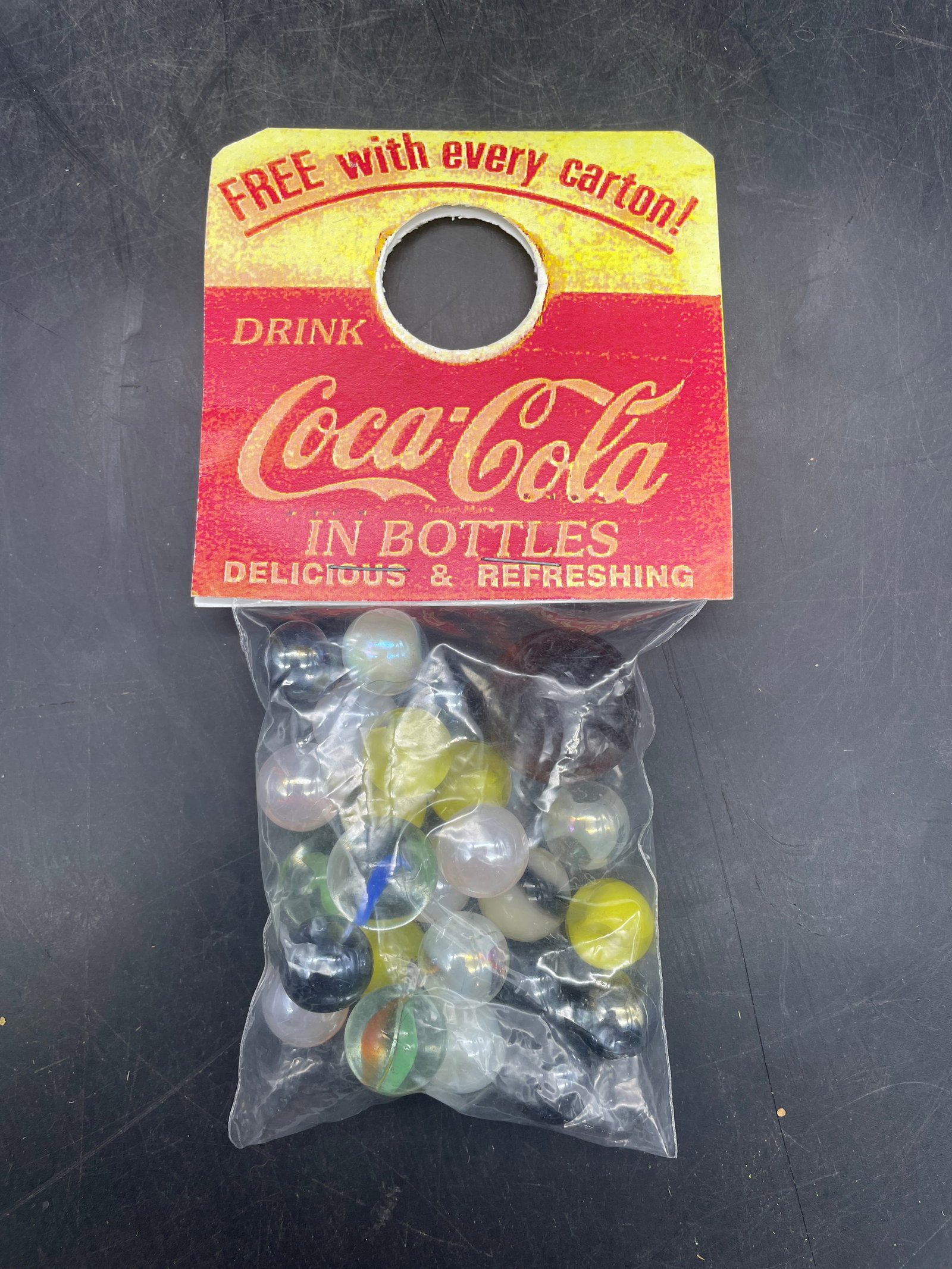 Coca Cola Promotional Marbles include Uranium Glass: Title: Coca Cola Promotional Marbles include Uranium Glass Date/Period: UNKNOWN Dimension: various Material: unknown Additional Information: Coca Cola Promotional Marbles include a Uranium Glass marbl