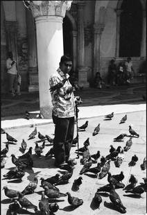 Blind Man Feeding Pigeons, Venice, Italy - Silver Gelatin: Title: Blind Man Feeding Pigeons, Venice, Italy - Silver Gelatin Photograph - Limited Edition of 10 Artist: Paul Cooklin Origin: United Kingdom Medium: Photography, Black & White on Paper Dimensions: