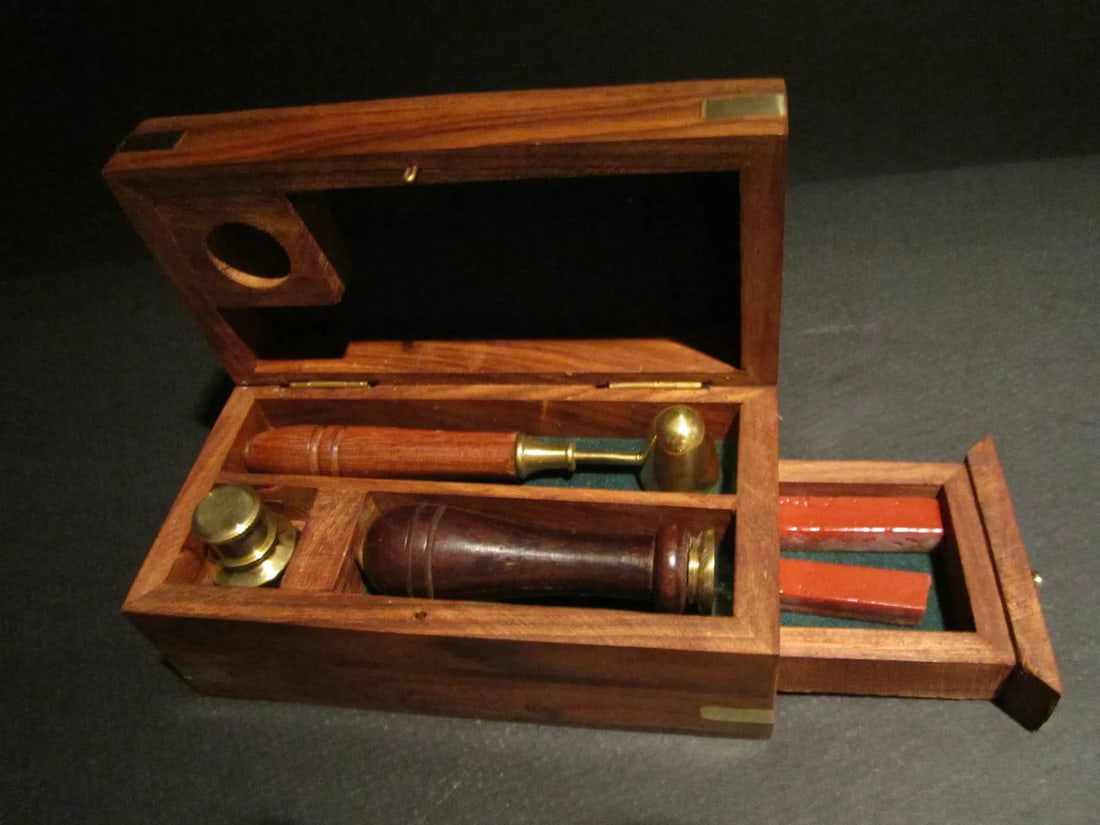 Letter Seal Wax Kit with Burner Spoon & Stamp: Description 5 1/2" Wide x 2 1/2" High x 2 3/4" Wide WAX SEAL KIT IN WOODEN BOX This reproduction of an antique wax seal kit has a solid brass burner, wax spoon with a wooden handle, a brass stamp with
