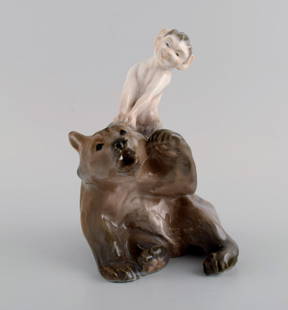Royal Copenhagen porcelain figurine. Faun pulling bear's ear. Model number 1804. 1920s.: Royal Copenhagen porcelain figurine. Faun pulling bear's ear. Model number 1804. 1920s. Measures: 19 x 13 cm. In excellent condition. Stamped. 2nd factory quality. Reserve: $875.00 