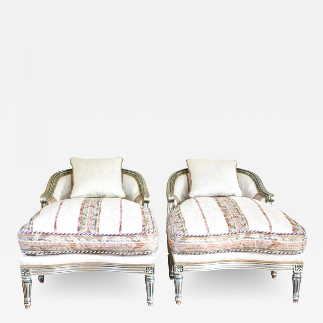 Hollywood Regency Louis XVI Chaise Lounges French Painted and Parcel Gilt Silver: Description: Hollywood Regency Louis XVI style chaise lounges or extended marquees. The pair in a fine French painted and parcel gilt silver decorated frame with an exquisite matching fabric. Having h