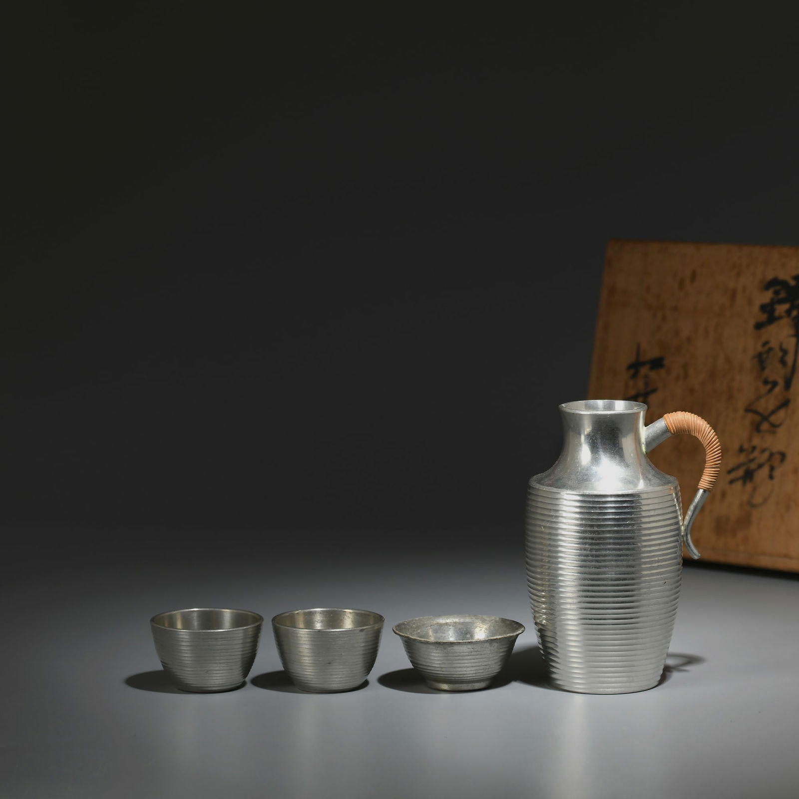 A set of wine glasses - Japanese Showa period tin wine flask and wine glasses: Title: A set of wine glasses - Japanese Showa period tin wine flask and wine glasses Origin: Asian private collection Date/Period: 20th Description: Size: Sake bottle about 10x7x6 rim/sake cup 4x4x2cm