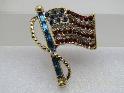 Vintage Red, White, Blue Rhinestone Flag Brooch 1980's: Vintage Red, White, Blue Rhinestone Flag Brooch 1980's. This flag has a blue rhinestone baguette flag pole - one stone ws missing but it has been replaced. The flay has the white and blue stars and re