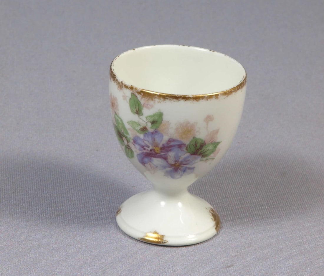 Limoges CH Field Haviland France EGG CUP Purple Flowers Clematis Vines: This is rare and hard to find Egg cup. The cup was made in CHField Haviland in Limoges, France. The cup is 1 7/8" in diameter and 2 3/8" deep It will make a wonderful gift or will be a great addition
