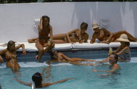 Pousada Dos Buzios ' By Slim Aarons Oversized C Type: Description ' Pousada Dos Buzios ' by Slim Aarons Friends by the pool at Pousada Dos Buzios in Brazil, August 1975. Left is student Fabian Crespo, lying on the cushions (without the hat) is Tania