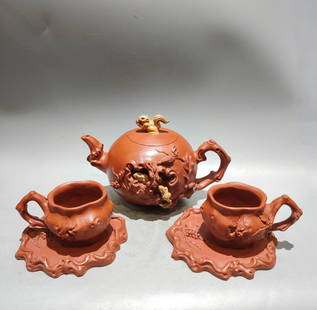 A Set Chinese Yixing Zisha Clay High Relief Squirrel & Grape Teapot w Cup & Saucer: Title: A Set Chinese Yixing Zisha Clay High Relief Squirrel & Grape Teapot w Cup & Saucer Date/Period: --- Origin: Chinese Dimension: 190 x 120 (mm)7.48 x 4.72 (inches)Dimension: 100 x 50 (mm)3.94 x 1