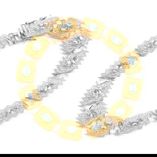 6.55 ctw Blue Topaz Antique Style 18K Gold Designer Bracelet 7.75 in: Title: 6.55 ctw Blue Topaz Antique Style 18K Gold Designer Bracelet 7.75 in Stone 1: Blue Topaz Color: Sky Blue Shape: Oval Size: 6x4 Quantity: 12 CTW: 6.55 Plating Material: 18K Yellow Gold Primary M