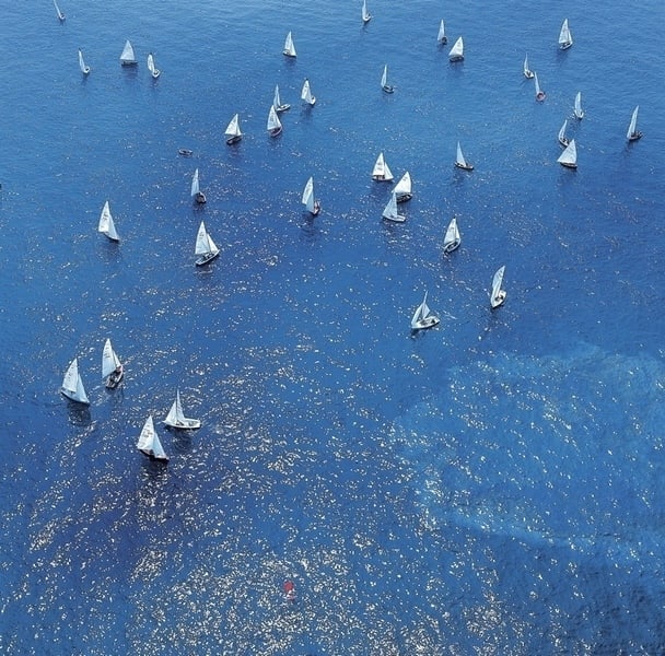 Regatta' 1973 C Type Print Framed In White: Description 'Regatta' 1973 C Type Print Framed In White Aerial view of the sailing boats in the Junior Regatta, with their white sails against the bright blue sea, San Remo, 1973 C Type Open Edition P