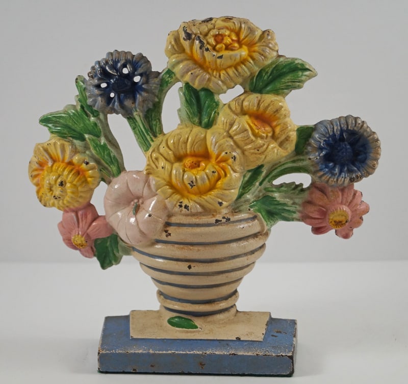 Antique Marigold Flowers Cast Iron Hubley Doorstop: Title: Antique Marigold Flowers Cast Iron Hubley Doorstop Dimension: 7 ¾” tall x 8” wide. Date: Ca. 1930’s. Additional Information: Charming array of Marigolds in ribbed Vase ca