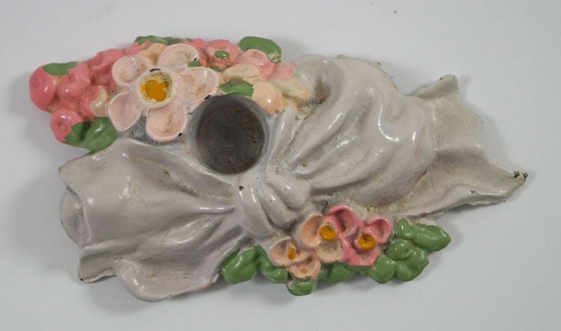 Antique Daisies w/ Bow Cast Iron Candle Holder w/ Box: Title: Antique Daisies w/ Bow Cast Iron Candle Holder w/ Box Dimension: 5 1/2” long x 3” wide x ¾” opening for candle. Box - 6 ½” long x 4 ¼” wide x 1 