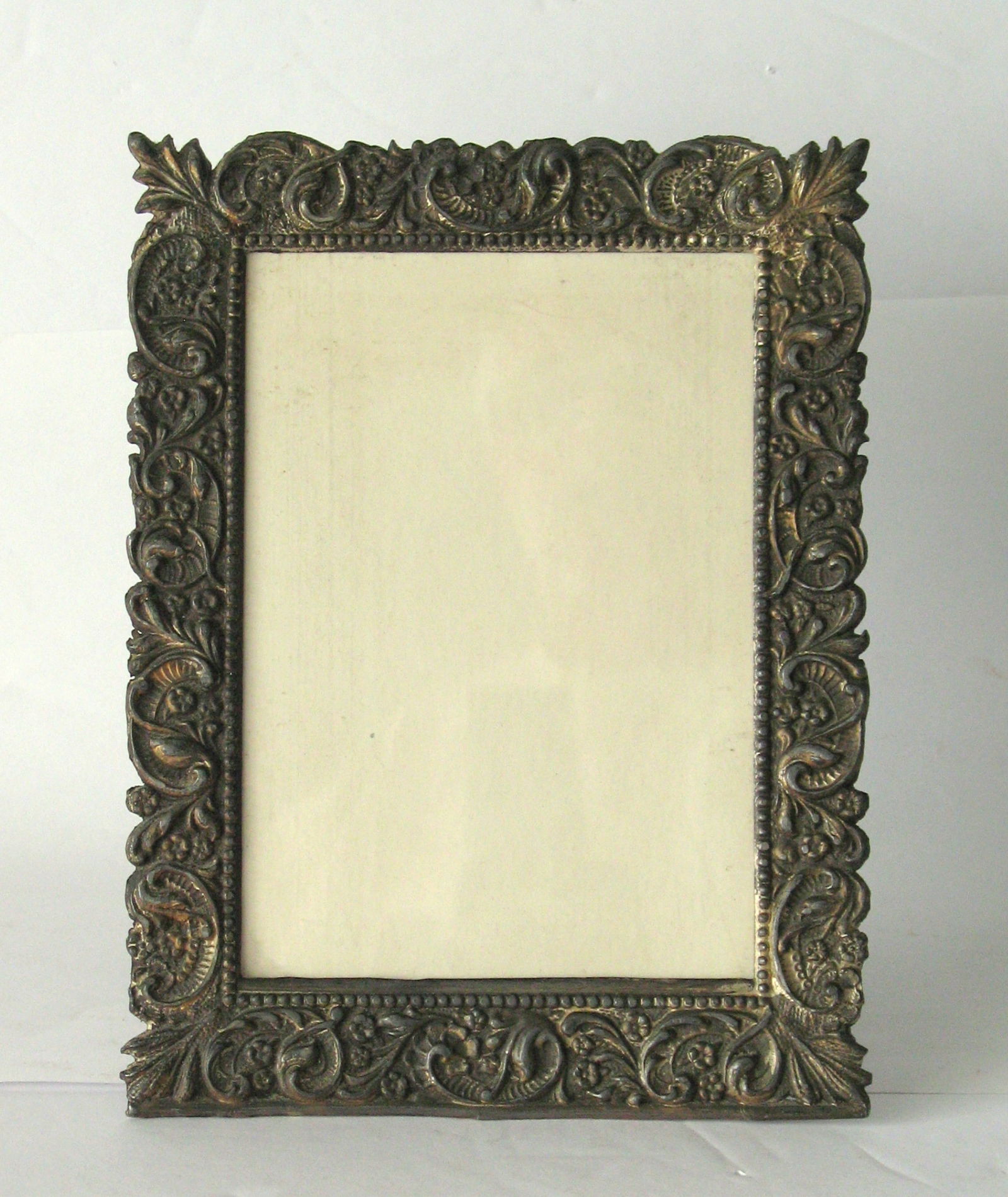 Antique brass table top picture frame.: Title: Antique brass table top picture frame. Date/Period: 1930's Dimension: O D 7” x 5”; I D 5” x 3 1/2” Additional Information: Nice antique cast brass table top picture fame
