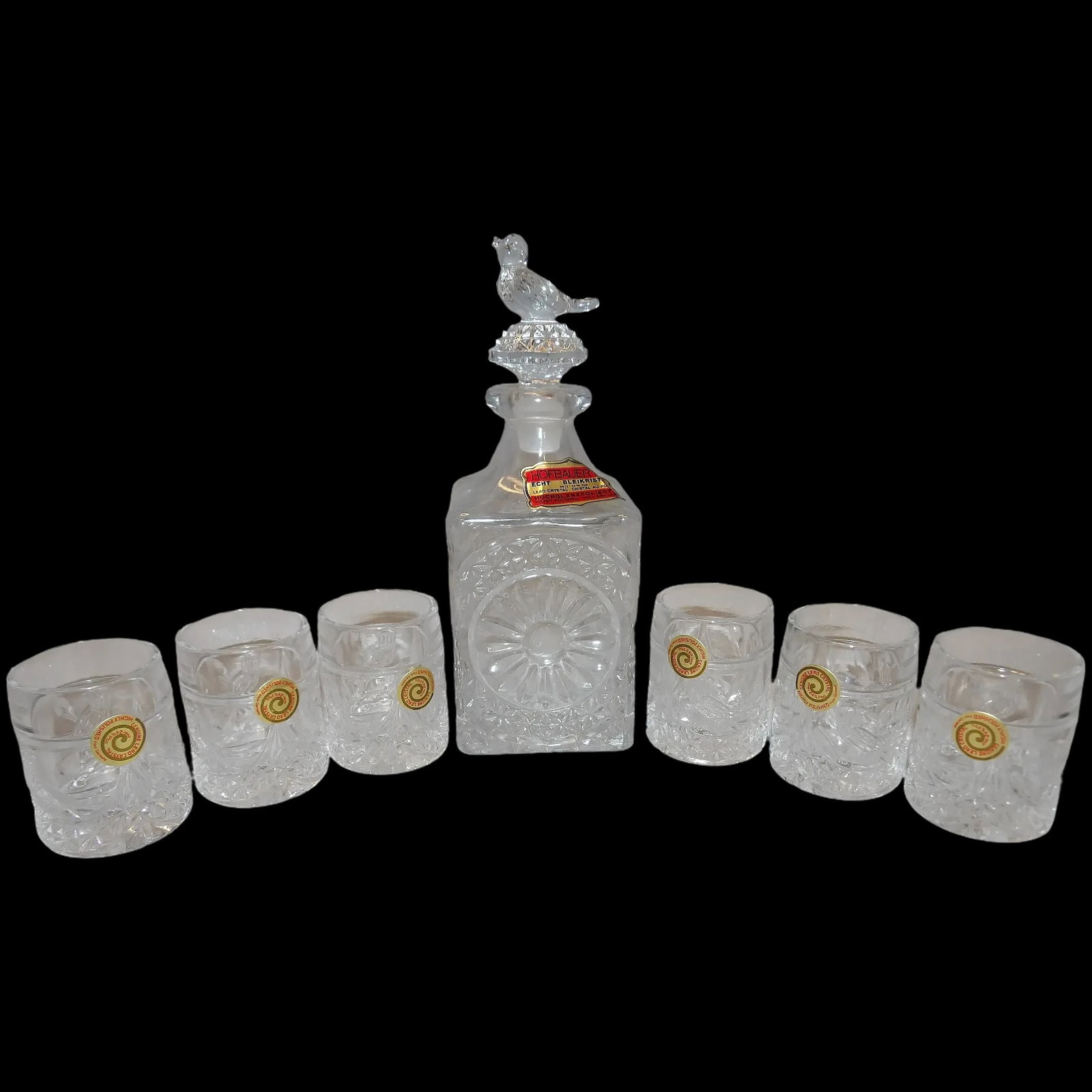 Hofbauer Byrdes 1950’s Crystal Decanter and 6 Matching Shot (tot) Glasses: Hofbauer Byrdes 1950’s Crystal Decanter and 6 Matching Shot (tot) Glasses is NOS. Each shot glass has the original sticker still attached. Comes in the original box. 24% lead crystal. Hand cut made 