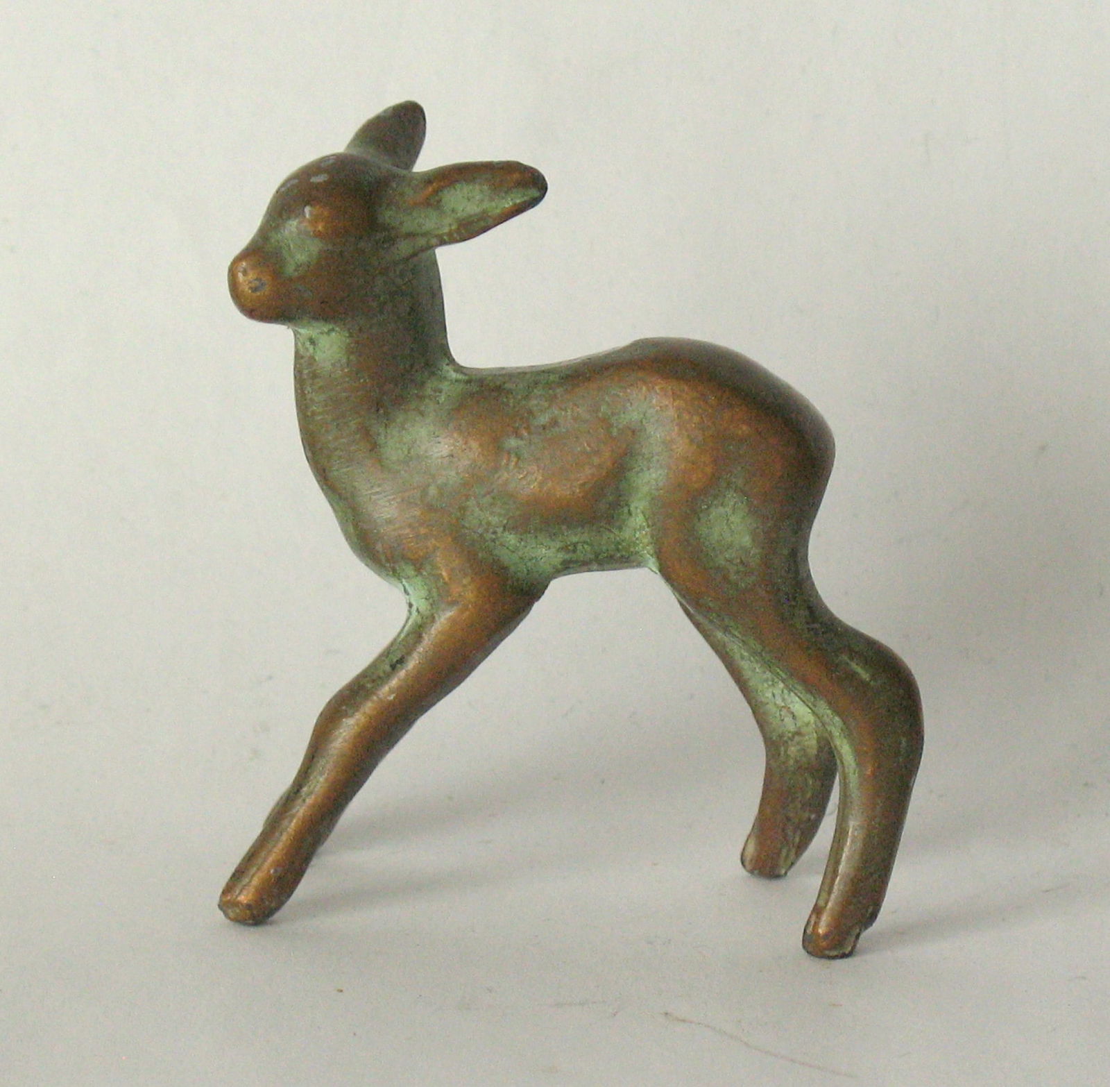 Vintage molded brass fawn paper weight.: Title: Vintage molded brass fawn paper weight. Date/Period: 1950's Dimension: 2” x 3/4” x 2 1/4” Additional Information: Nice vintage molded brass faun paper weight in al original pa