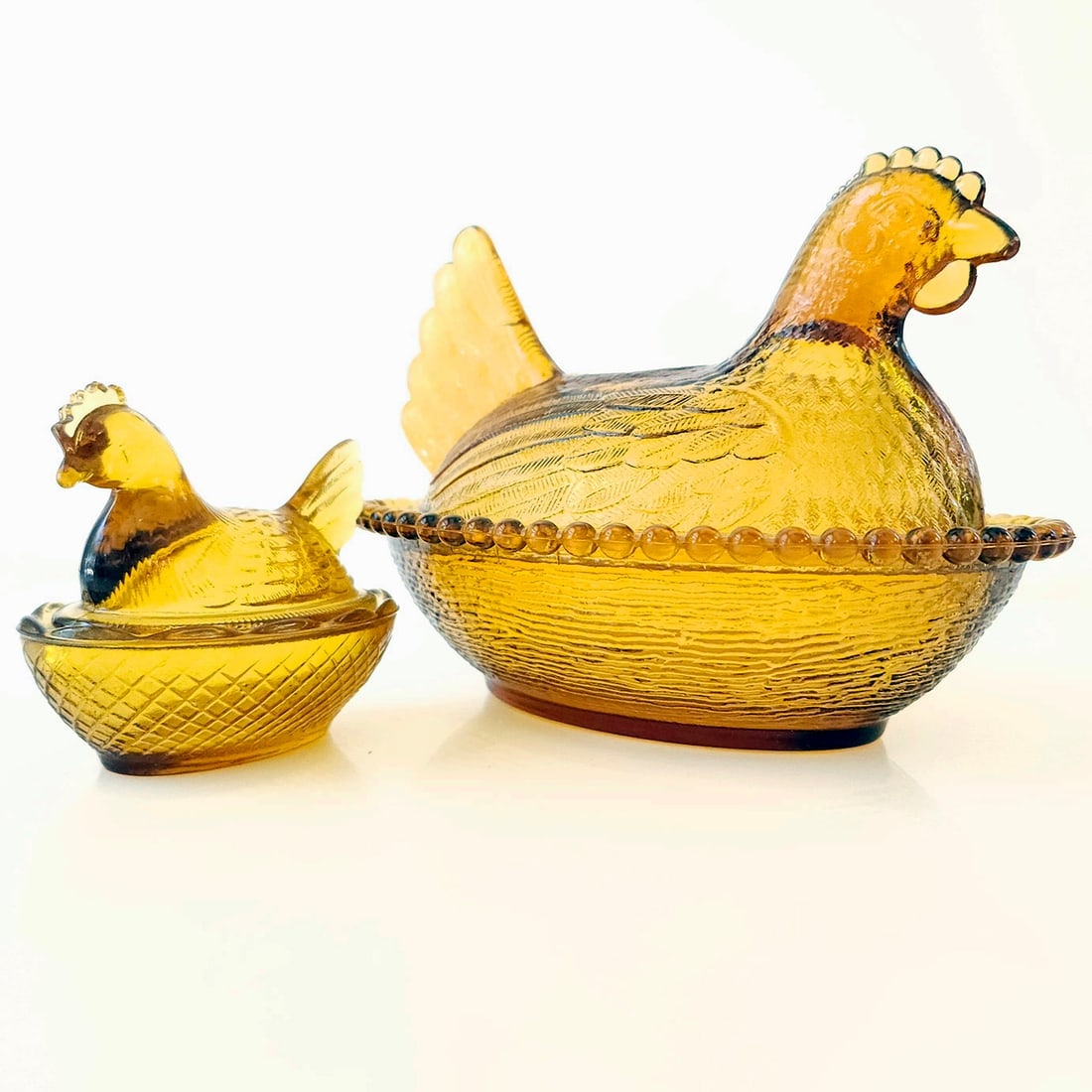 Indiana Glass Company Amber Colored Hen on the Nest circa 1970’s set of 2: Title: Indiana Glass Company Amber Colored Hen on the Nest circa 1970’s set of 2 Description: Larger one has striated glass base, beaded rim and circle marking typical of Indiana Glass (made in
