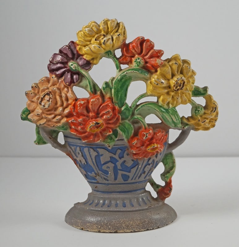 Antique Zinnias Flower Cast Iron Hubley Doorstop: Title: Antique Zinnias Flower Cast Iron Hubley Doorstop Dimension: 7 1/4” tall x 7” wide. Date: Ca. 1930’s. Additional Information: Charming array of Zinnias in ornate Vase cast iron