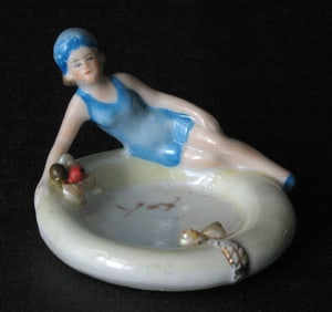 Antique porcelain Florida bathing beauty figurine.