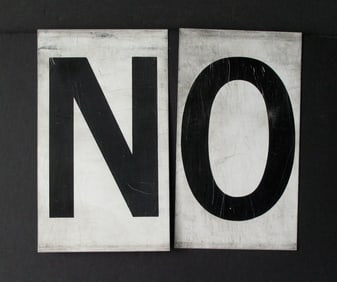 Antique tin movie marque letters “NO”.