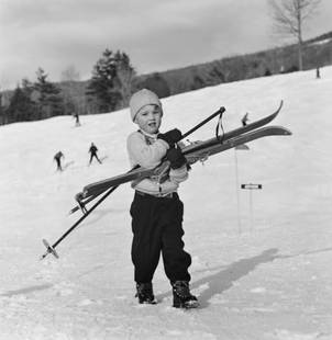 Slim Aarons 'New England Skiing Starters' 1955 Silver Gelatin Print Framed In Black: Description Slim Aarons 'New England Skiing Starters' 1955 Silver Gelatin Print Framed In Black A young skier prefers to carry his skis down the slope in New Hampshire, 1955. (Photo by Slim Aarons) Si