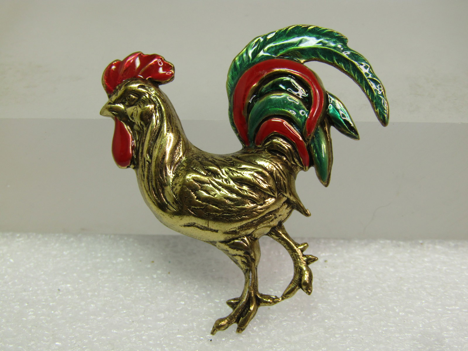 Vintage Enameled Rooster Brooch, 1960's-1970's: Vintage Enameled Rooster Brooch, 1960's-1970's. Gold tone with raised body with details and red and green enameled in the feathers and comb and waddle. The rooster is appx. 1.75" tall and wide. The pi