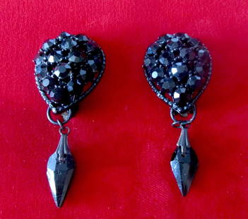 Pair of Vintage Black Crystal Clip-On Earrings: Pair of Vintage Black Crystal Clip-On Earrings Circa. 1950 American Black metal tear drop shaped earrings Marked "Weiss" Adorned with black round glass crystals that really shimmer! Small black tear-d