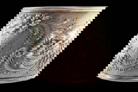 Silver napkin ring with raised floral motifs surrounding a monogram card: Description: Silver napkin ring with raised floral motifs surrounding a monogram card. Metal: Silver. Origin: Portuguese. Brand: Javali II Title. Weight: 18.27 grams | 0.64 ounces. Dimensions: 4.7x4 c