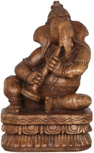 Musician Ganesha Wooden Idol Playing Shehnai: Title: Musician Ganesha Wooden Idol Playing Shehnai Description: South Indian Temple Wood Carving Height: 12 inch Width: 5 inch Depth: 7.5 inch Weight: 1.80 kg Additional Information: Lord Ganesha the