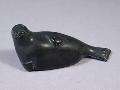Soapstone Inuit Native Canada Figurine Seal Sea Lion Label SIGNED: This is a vintage, Primitive Native American Canadian Inuit Figurine. It is signed at the bottom under the sticker. The figurine is made from black soapstone and is beautiful. The carving is app. 5" l