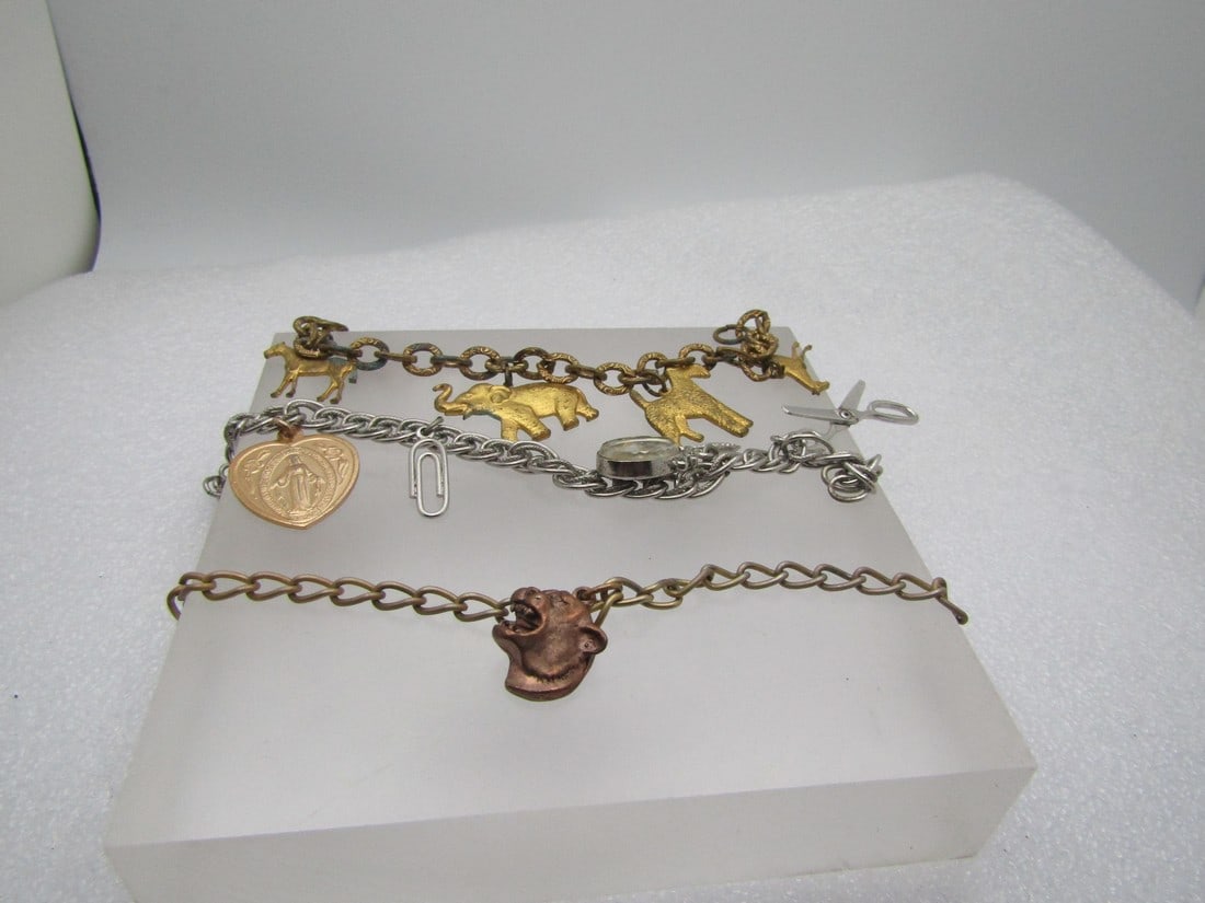 3 Vintage Charm Bracelets, Panther, Animals, and Mixed Charms, 1940's-1970's: 3 Vintage Charm Bracelets, Panther, Animals, and Mixed Charms, 1940's-1970's. The first is a 1940's-1950's gold tone animal charm bracelet, scottie dog, horse, elephant, airdale, horse with a stamped