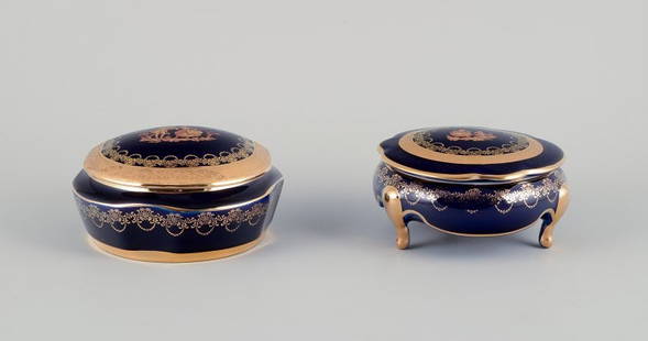 Limoges, France. Two lidded porcelain jars decorated with 22-karat gold leaf and featuring a: Limoges, France. Two lidded porcelain jars decorated with 22-karat gold leaf and featuring a beautiful royal blue glaze with a Sc&#232;ne galante. Approximately 1970. Provenance: From a large French p