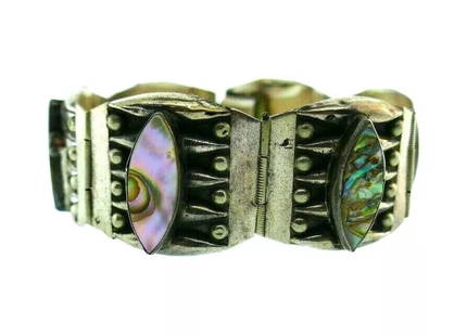 VINTAGE Sterling Silver & Mother of Pearl Bracelet American Indian: DK Vintage Sterling Silver & Mother of Pearl Bracelet American Indian · This is a must for a collector. The weight is 32.3 grams. The length is 7 1/4 inches. The height is 1 inch. Reserve: $400.0