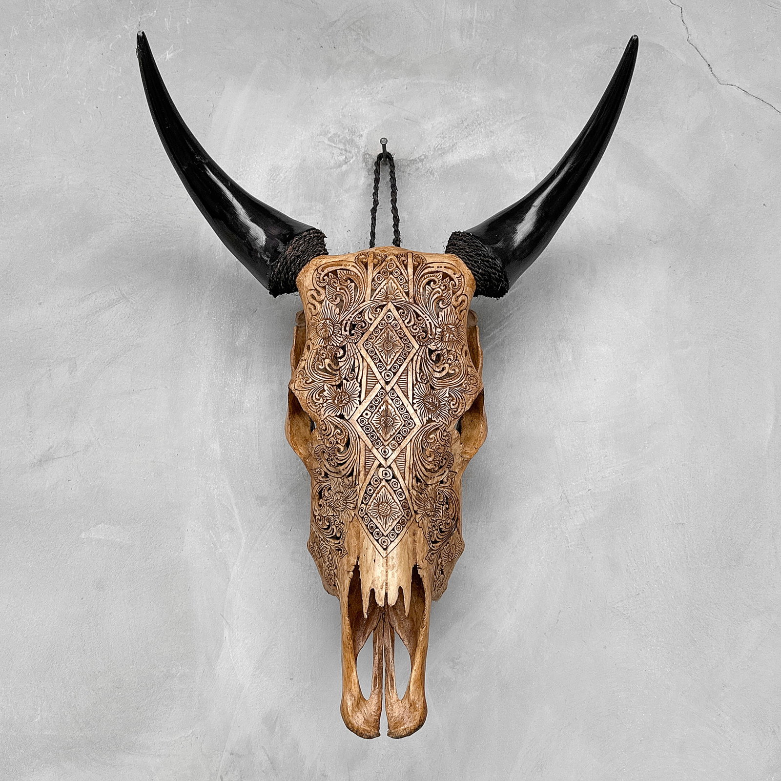 Carved brown cow skull - Ketupat motif: Title: Carved brown cow skull - Ketupat motif Maker:Unknown Origin: Indonesia Date/Period:2025 Materials:Bos Taurus, Bone, Horn Dimensions:Height: 58 cm / 22.8 inches Width: 43 cm / 16.9 inches Descri