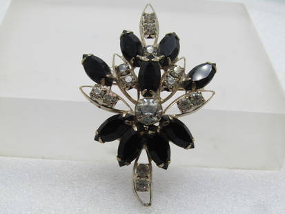 Vintage Black Clear Rhinestone Brooch, 1950's-1960's: Vintage Black Clear Rhinestone Brooch, 1950's-1960's. Pinted cluster brooch with black glass marquise stones and clear round stones. Gold tone and appx. 2.75" tall and 1.75" wide. The clear stones are