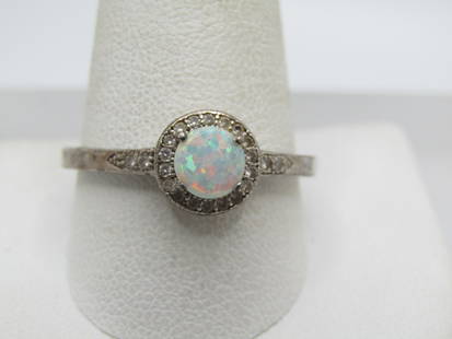 Sterling Opal & Diamond Halo Ring, Sz. 12: Sterling Opal & Diamond Halo Ring, Sz. 12. This has an appx 5.5mm round lab created opal with a micro diamond halo and a few diamonds on the upper band. It is marked .925 and tested. Weight of the rin