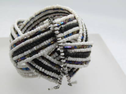 Vintage Seed Bead Woven Cuff Bracelet, Adjusts to Size, 1980's: Vintage Seed Bead Woven Cuff Bracelet, Adjusts to Size, 1980's. White glass seed eaes with peacock tube glass beads and black braided center. There are three bands that are braided in a wide braid and