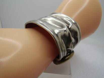 Vintage Sterling & Brass Modernist/Brutalist Cuff Bracelet, 6.75, Hand Made, 1970's-1980's: Vintage Sterling & Brass Modernist/Brutalist Cuff Bracelet, 6.75, Hand Made, 1970's-1980's. Estate sterling bracelet that is 1.5" wide with a wrinkled design and on the other end it is slightly gather