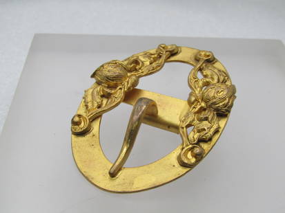 Vintage Victorian Themed Buckle, Floral: Vintage Victorian Themed Buckle, Floral. Gold tone and 2.5" wide and 1.5" tall - oval with a floral repousse design on top and bottom. It has a faux hook with the tab on the bottom and a whole on the