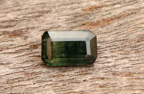 Natural green Teal Sapphire 0.80 carat: Title:Natural green Teal Sapphire 0.80 carat Additional Info:Gemstone: Natural SapphireCarat Weight: 0.80Shape/Cut: Emerald CutMeasurements: 6.47x4.04x2.65 mmColor: Dark GreenTransparency: Transparent