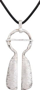 FINE VIKING PROTECTIVE BROOCH 900-1050 AD: Gilt bronze with round top, over 7/8” diameter with the cross pin. 2 1/8” height plus the loop. The terminals flared to long broad medially ridged tails. When fastened to the jerkin, these