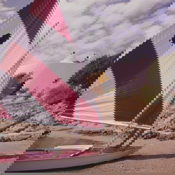 Slim Aarons 'Bettina Graziani' 1964 C Type Print Framed In White: Description Slim Aarons 'Bettina Graziani' 1964 C Type Print Framed In White French fashion model Bettina Graziani (Simone Micheline Bodin) (1925 – 2015) adjusting the sail of a boat, Costa Smer