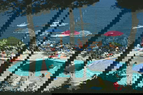 Pellicano Pool ' By Slim Aarons Oversized C Type: Description ' Pellicano Pool ' by Slim Aarons Holidaymakers relax beside the swimming pool of Il Pellicano Hotel in Porto Ercole, Tuscany, August 1980. (Photo by Slim Aarons/Hulton Archive/Getty Image