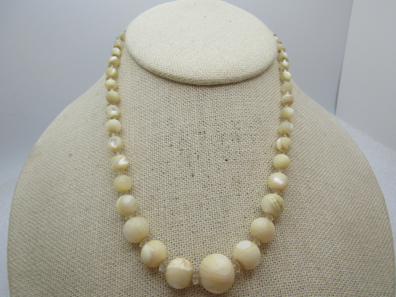 Vintage Graduated Mother-of-Pearl Beaded Neckace, 15", 1940's-1950's: Vintage Graduated Mother-of-Pearl Beaded Neckace, 15", 1940's-1950's. Graduated mother-of-pearl beads appx 4mm to 11.5mm with crystal faceted beads between. This has a celluloid style barrel clasp. It