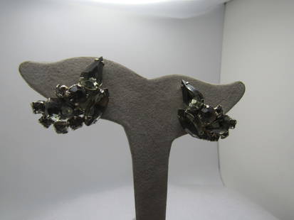 Vintage Smoky Rhinestone Clip Earrings, 1940's-1960's: Vintage Smoky Rhinestone Clip Earrings, 1940's-1960's. Silver tone with round, marquise, and pear-shaped glass rhienstones. They are appx. 1.25" long and 5/8" wide. They are curved and domed. Under a