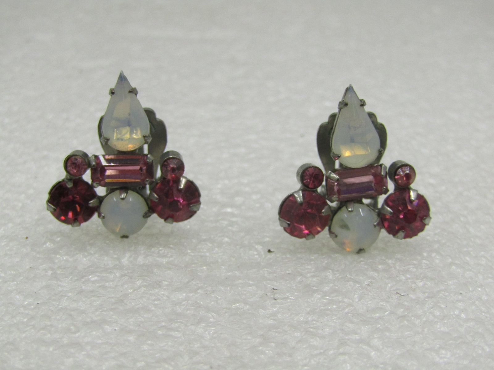 Vintage Pink and White Rhinestone Earrings, Clip, 1940's-1950's: Vintage Pink and White Rhinestone Earrings, Clip, 1940's-1950's. Silver tone setting with a pear and round shaped faux opallish to white stones that are appx. 6mm round and 10mm pear-shaped with a lig