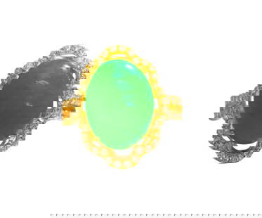 Jade & Diamond Ring in 18k Yellow Gold.: Metal: 18k yellow gold. Center stone: 6.05 carat jade. Side diamonds: 1.25 carat total. Round shape zirconias. Total weight: 4.6 grams. Ring size: US 7. Womens collectible 18k gold and jade ring. Rese