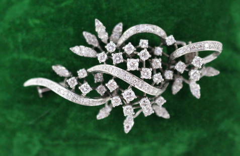 Mid-Century Diamond Foliate Brooch in 18 Carat White Gold: Mid-Century Diamond Foliate Brooch in 18 Carat White Gold A refined and beautifully made diamond brooch dating from the mid-20th century, crafted in 18ct white gold. Designed in an elegant foliate scr
