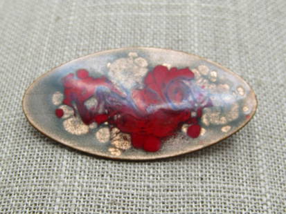 Vintage Enameled Over Copper Brooch, Swirled Red, 1960's-1970's: Vintage Enameled Over Copper Brooch, Swirled Red, 1960's-1970's. It is oval and appx. 2" wide and 1" tall with a locking clasp. Base metal is copper with a translucent enameling over gold tone flecks