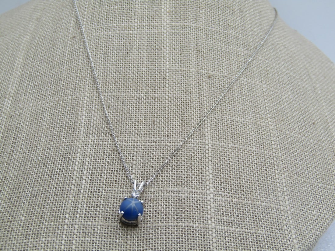 Vintage Faux Star Blue Sapphire Necklace, 17", 1970's-1980's, Marked Sterling: Vintage Faux Star Blue Sapphire Necklace, 17", 1970's-1980's, Marked Sterling. The pendant is appx. 3/4" long with a 6,5mm round faux blue star sapphire and a single clear rhinestone,. The chain has t