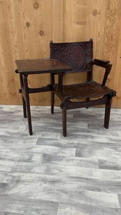 Vintage Tooled Leather Primitive Gossip Chair by Angel Pazmino: Vintage from before 2000 Vintage Tooled Leather Primitive Wood Base Gossip Chair by Angel Pazmino Rare and Unique Vintage carved walnut and hand tooled leather sling chair that is attached with a tool