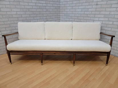 Mid Century Modern Danish Walnut Frame Sofa by Ib Kofod-Larsen Newly Upholstered: Vintage from before 2000 Materials: shearling, wood, walnut, wool, sheep wool Overall width: 69 inches Overall height: 30 inches Overall depth: 30 inches Seat height: 18 inches Mid Century Modern Dani