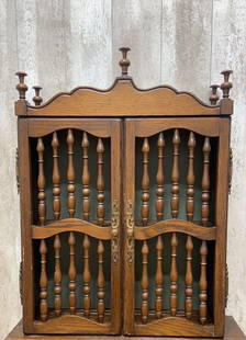 Vintage Wooden Carved Wall Hanging Shelving Unit: Vintage from before 2000 Materials: wood Vintage Wooden Carved Wall Hanging Shelving Unit The Vintage Wooden Carved Wall Hanging Shelving Unit features two intricately carved doors that provide a glim